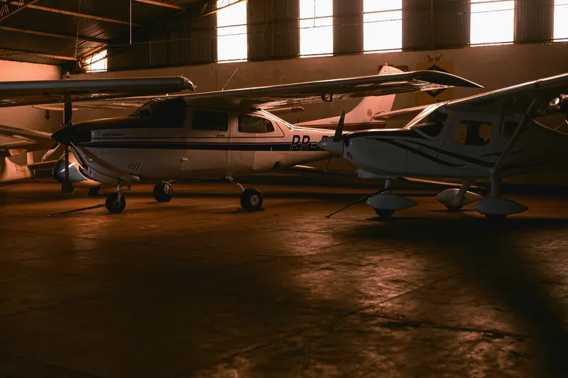 Small aircraft inside an aviation hangar.