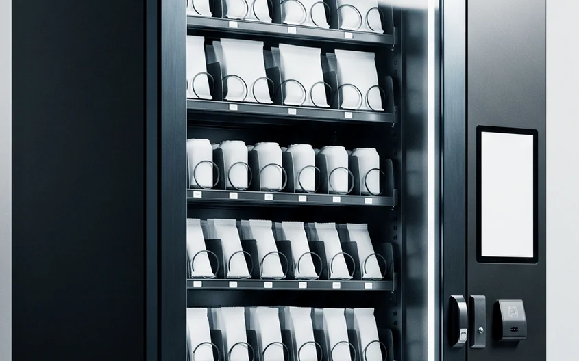 Interior shelving of a machine, items arranged in rows.